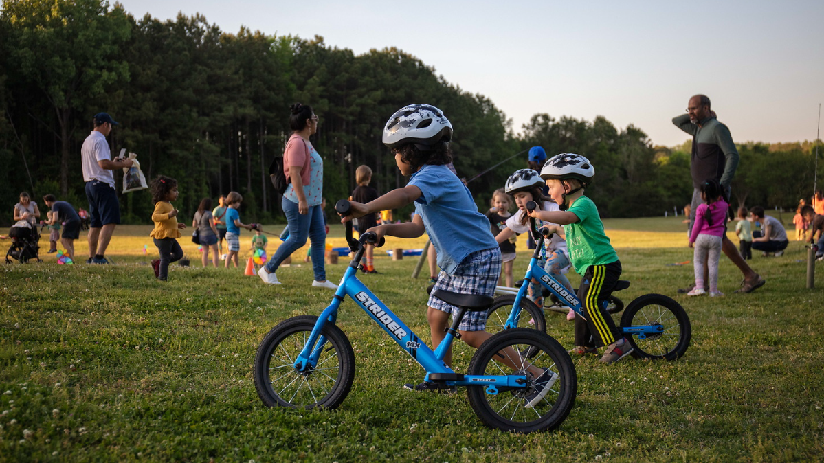 Kids on balance bikes at Earth Day 2022