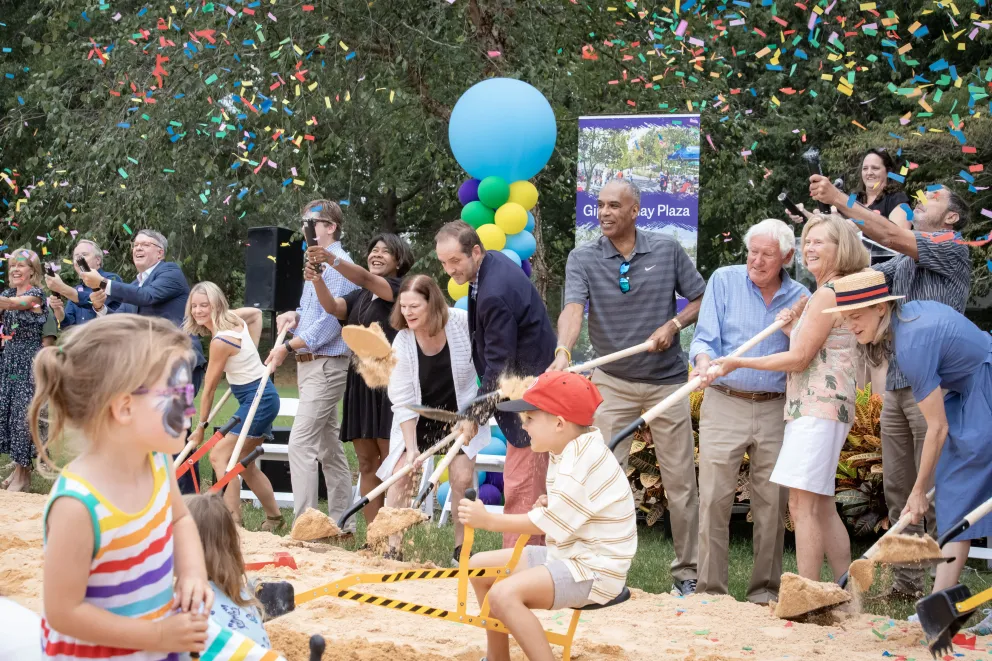 People with shovels at groungbreaking with confetti
