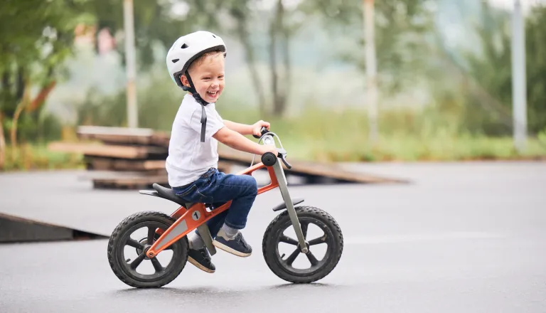 Small child riding balance bike