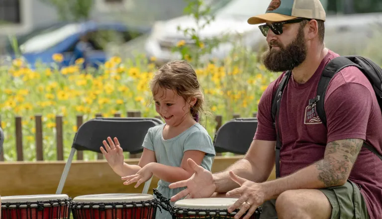 girl and man drumming