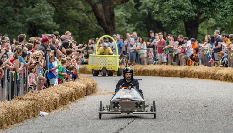 Two soapbox carts racing at Dix Park during Kirby Derby 2025