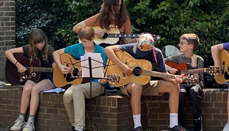 young adults playing guitars