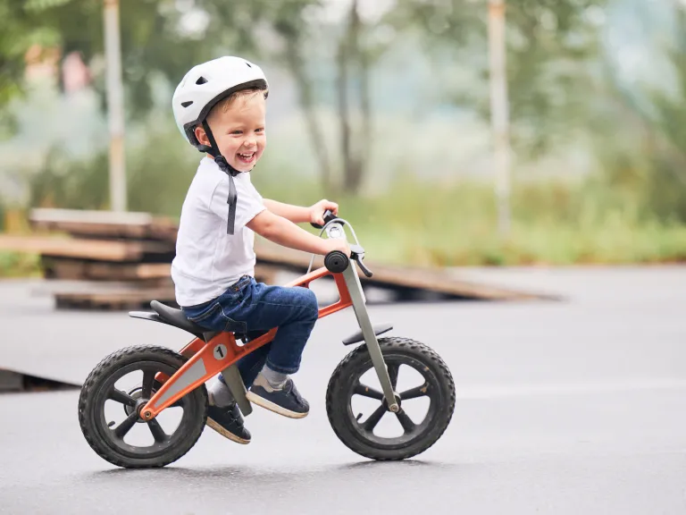 Small child riding balance bike