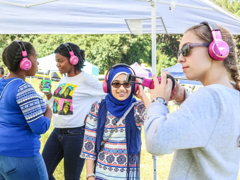 Teen girls at silent disco at Dix Park event