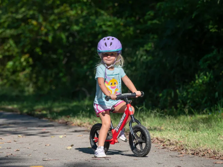 Child on balance bike on the greenway