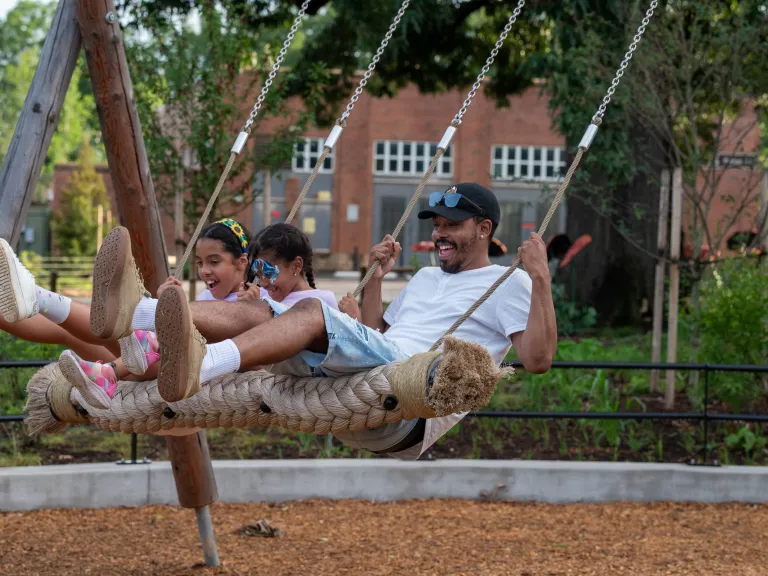 Gipson Play Plaza family on the swing terrace 