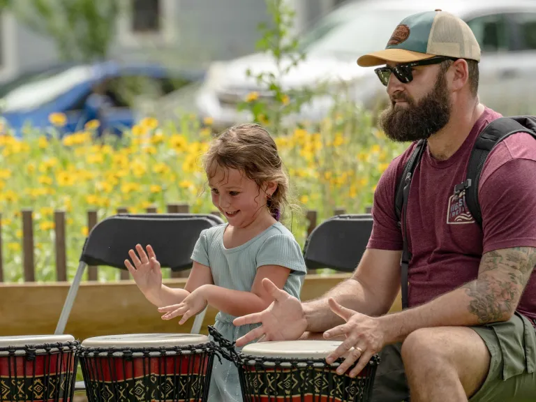 girl and man drumming