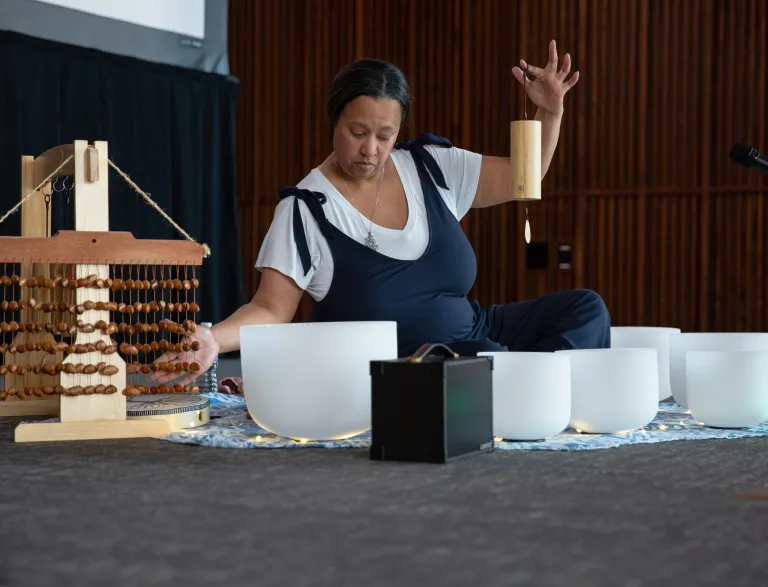 Woman performing sound bath