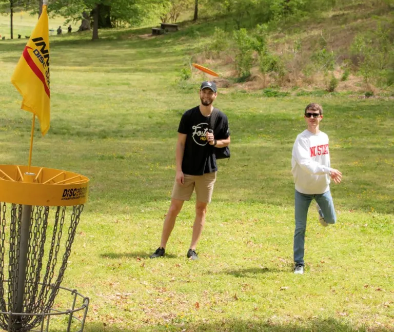 Two Disc Golf players putting